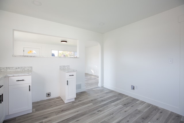 laundry room with light wood-type flooring