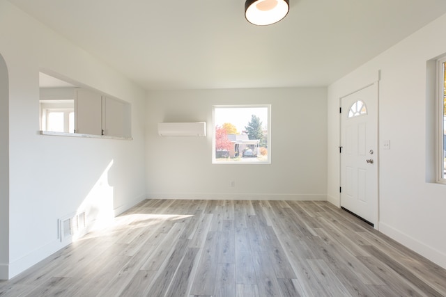 entryway featuring an AC wall unit and light wood-type flooring