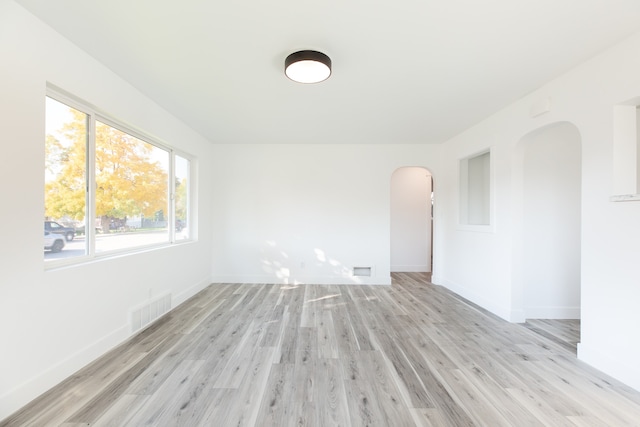 unfurnished room with light wood-type flooring