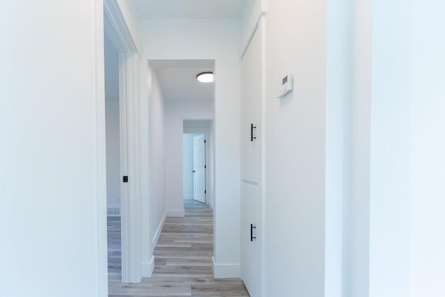 hallway with light wood-type flooring