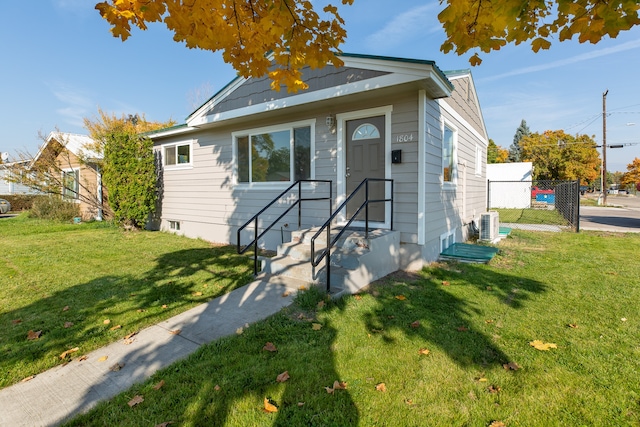 bungalow-style house with a front lawn