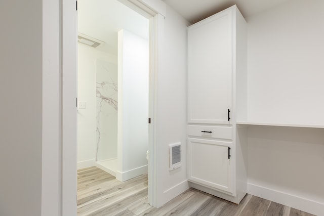 interior space with light hardwood / wood-style floors and heating unit