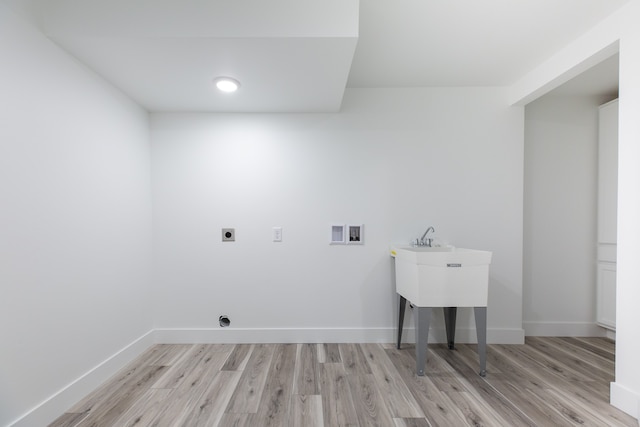 washroom with electric dryer hookup, washer hookup, and light wood-type flooring