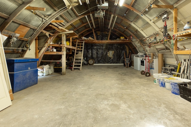 unfinished attic with washing machine and clothes dryer