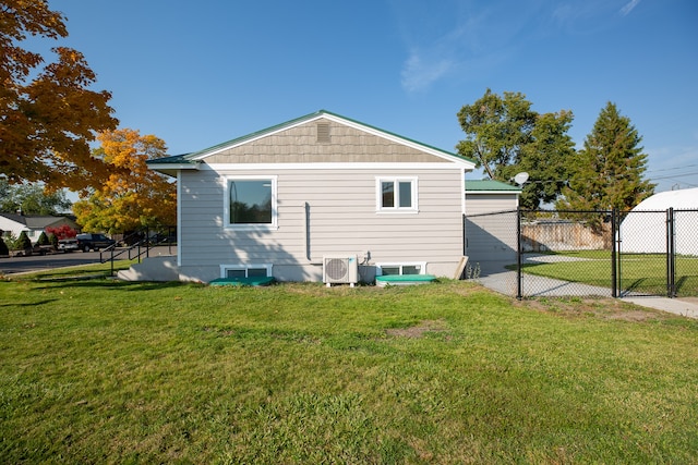 rear view of house featuring a yard