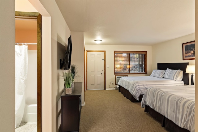 bedroom with carpet flooring and a wall unit AC