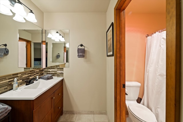 bathroom featuring backsplash, vanity, toilet, and tile patterned flooring