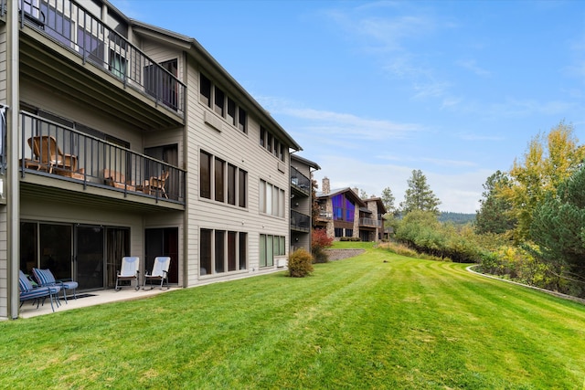 view of yard featuring a patio area and a balcony