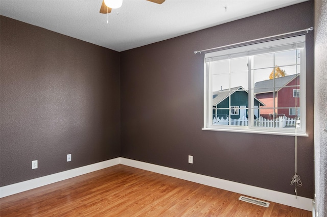 spare room featuring hardwood / wood-style floors and ceiling fan