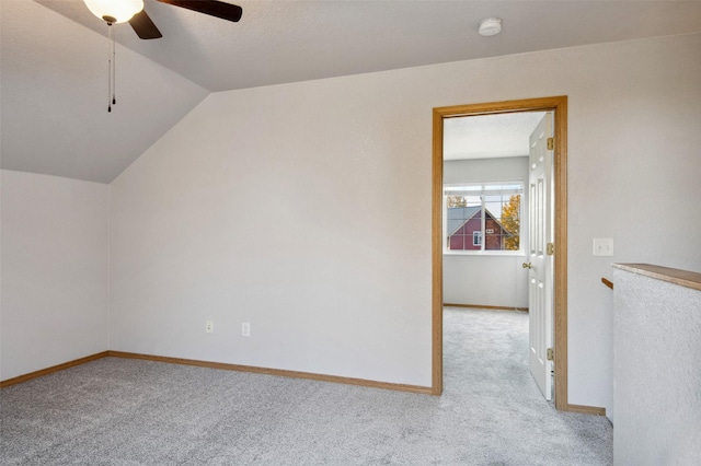 additional living space featuring ceiling fan, light colored carpet, and vaulted ceiling