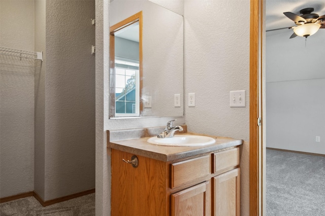 bathroom with ceiling fan and vanity