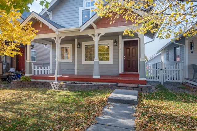 view of front of house with a front yard and a porch