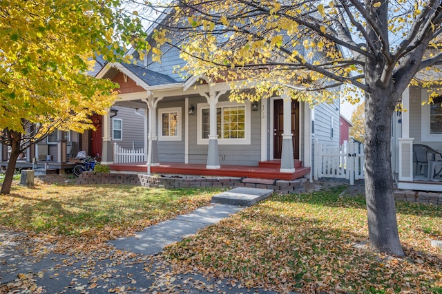 view of front of house with a porch and a front lawn