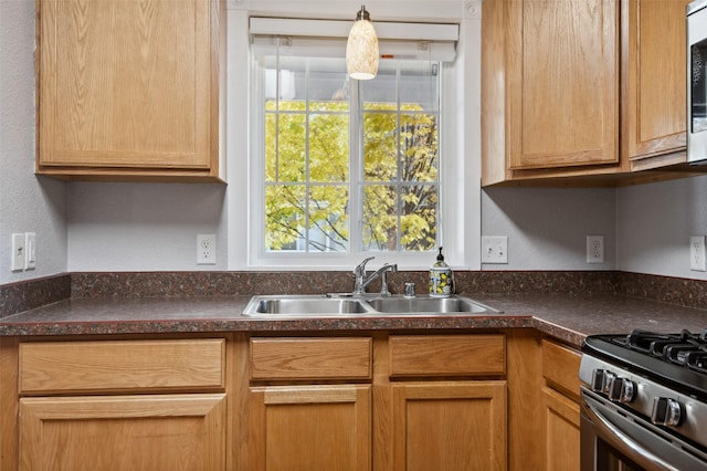 kitchen with stainless steel gas range oven, sink, and a healthy amount of sunlight