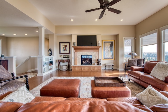 living room featuring decorative columns and ceiling fan