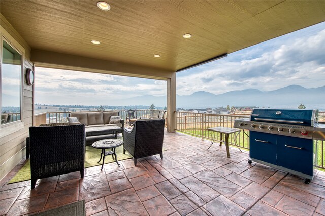 view of patio / terrace featuring outdoor lounge area, a mountain view, and a grill