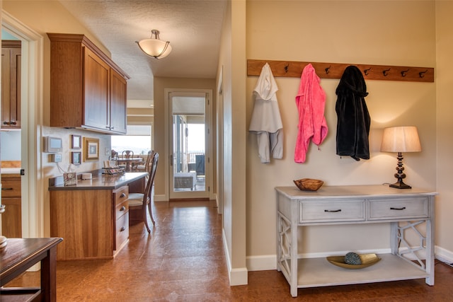 mudroom featuring a textured ceiling