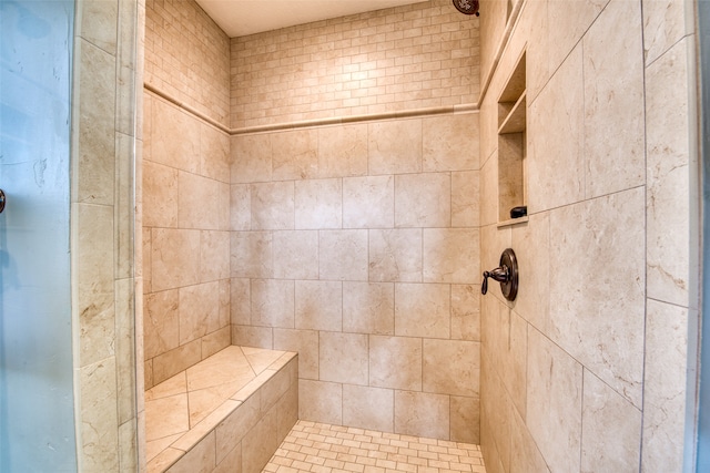 bathroom with a tile shower