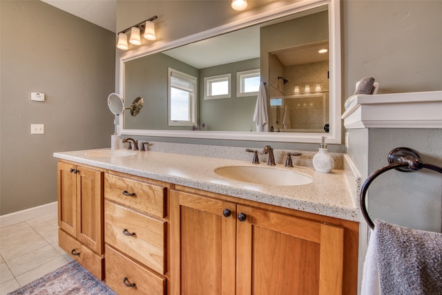 bathroom featuring tile patterned floors, vanity, and a tile shower