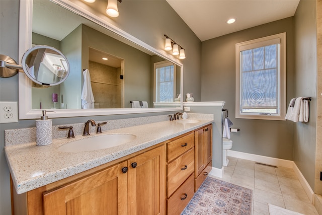 bathroom featuring tile patterned flooring, vanity, and toilet