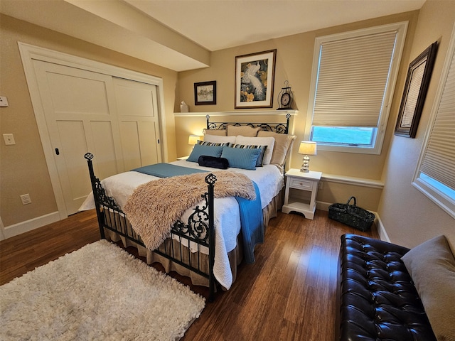 bedroom featuring a closet and dark wood-type flooring