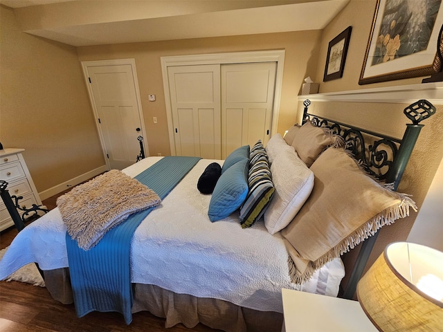 bedroom featuring dark hardwood / wood-style floors and a closet