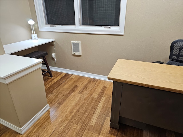 home office with light hardwood / wood-style flooring