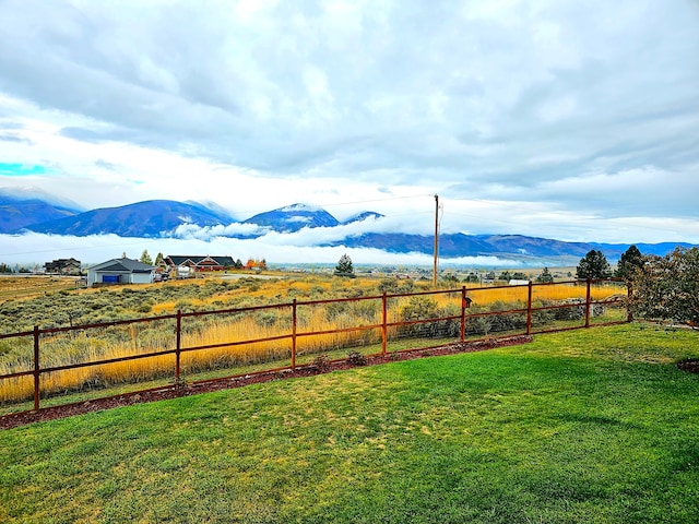 view of yard with a mountain view and a rural view