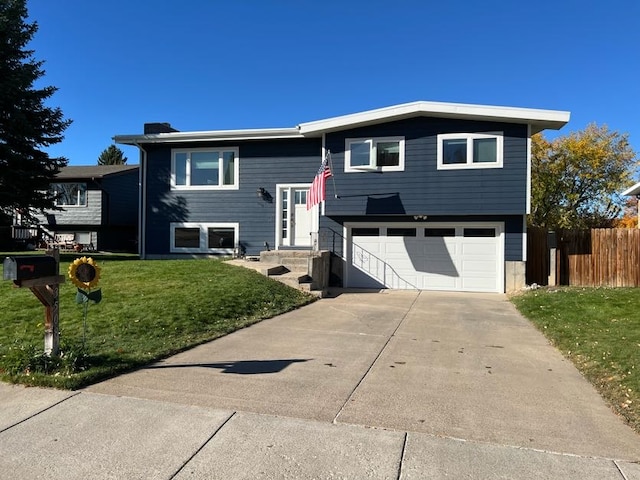 bi-level home featuring a front lawn and a garage