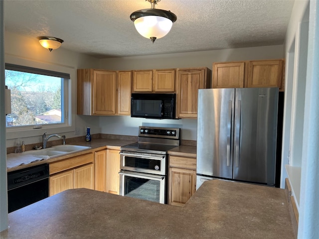 kitchen with light brown cabinets, sink, a textured ceiling, and black appliances