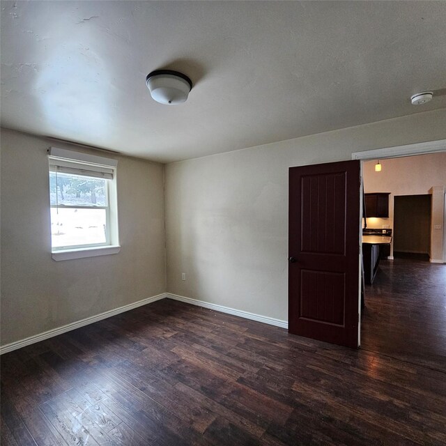 empty room featuring dark hardwood / wood-style floors