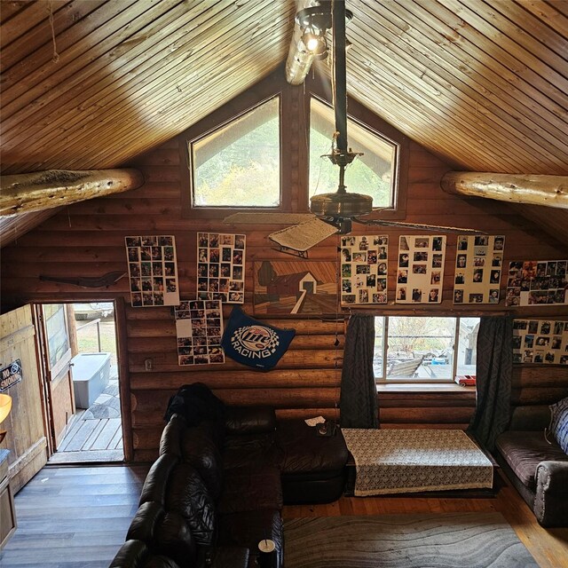 living room with lofted ceiling, hardwood / wood-style flooring, wooden ceiling, and rustic walls