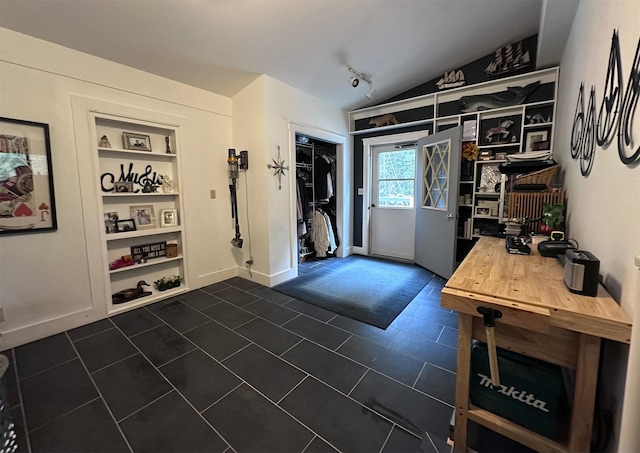 tiled entrance foyer featuring vaulted ceiling