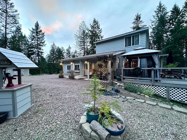 view of front of home featuring an outbuilding and a wooden deck