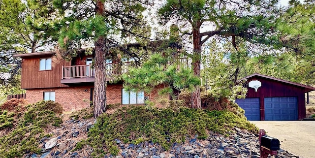 view of front of house with brick siding and a balcony