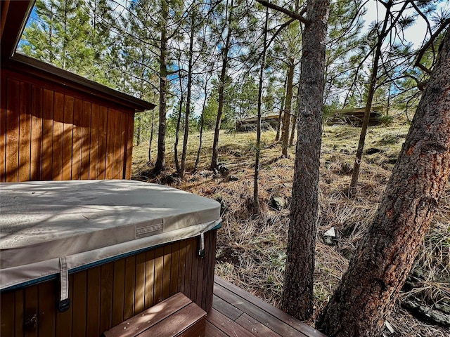 wooden deck with a hot tub