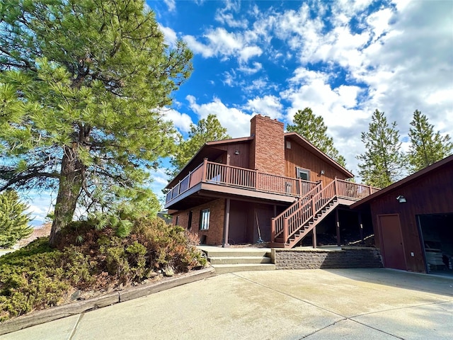 rear view of house featuring a deck