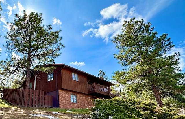 view of side of home with a balcony