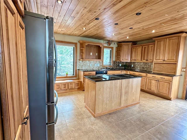 kitchen featuring freestanding refrigerator, open shelves, decorative backsplash, recessed lighting, and a sink