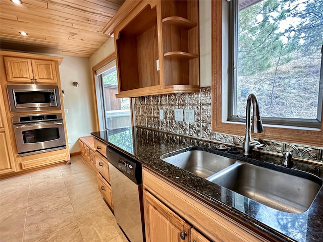 kitchen with backsplash, sink, appliances with stainless steel finishes, dark stone counters, and wooden ceiling