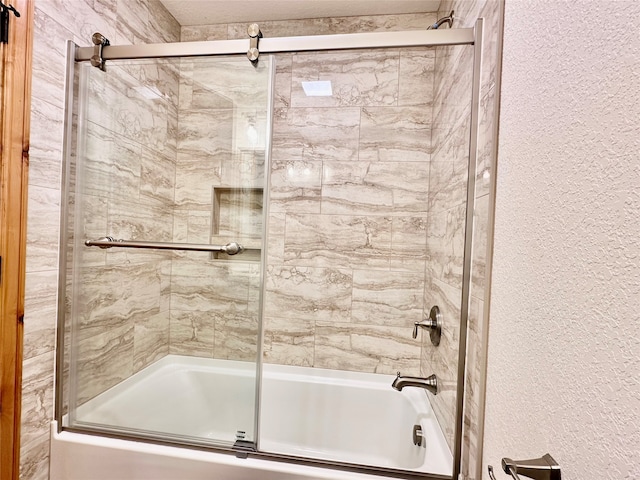 bathroom featuring combined bath / shower with glass door