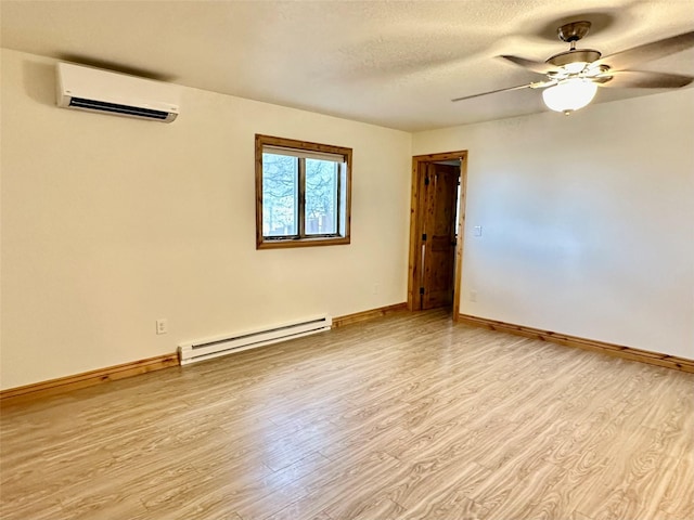 unfurnished room featuring light wood-style floors, baseboards, baseboard heating, an AC wall unit, and a ceiling fan