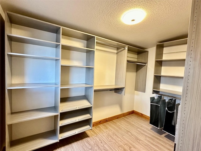 spacious closet with light wood-style flooring