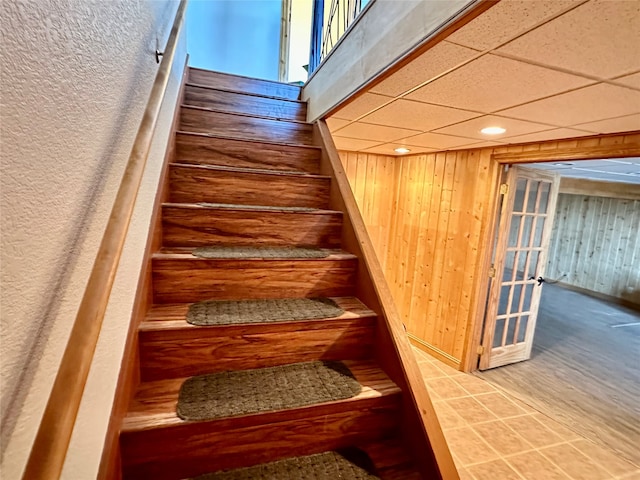 stairs featuring a paneled ceiling