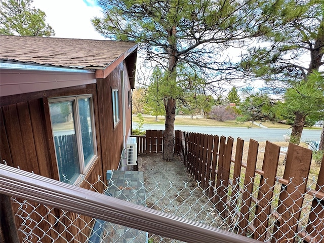 view of side of property with central air condition unit