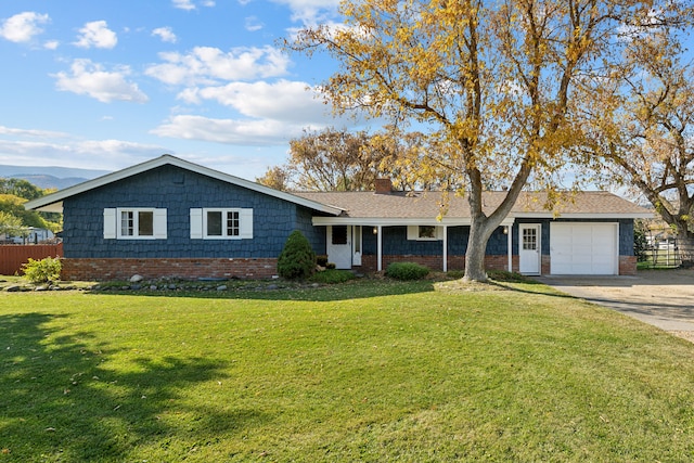 ranch-style home with a front yard and a garage