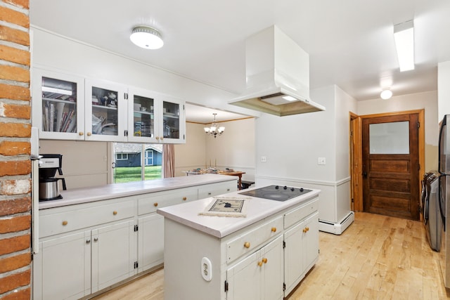 kitchen featuring white cabinetry, a center island, black electric cooktop, custom range hood, and light wood-type flooring