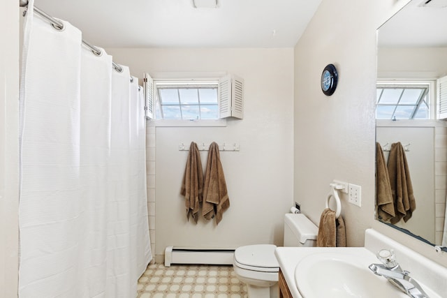 bathroom featuring baseboard heating, vanity, and toilet