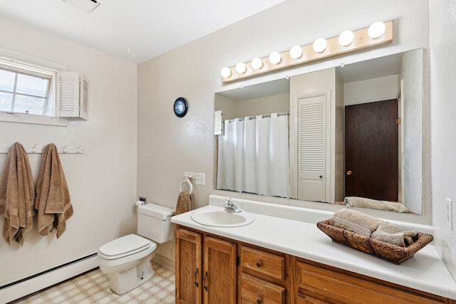 bathroom with vanity, toilet, and a baseboard heating unit