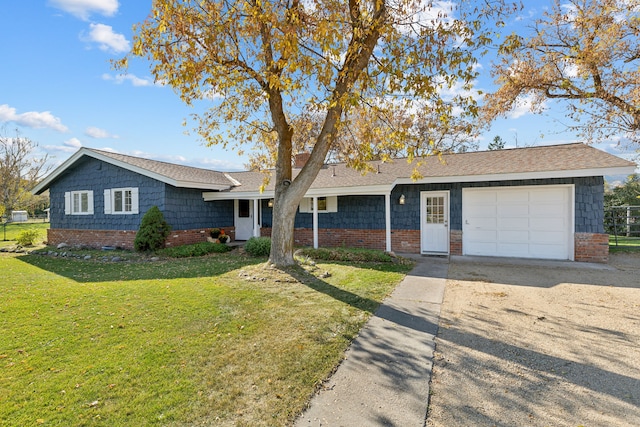 ranch-style house featuring a front yard and a garage